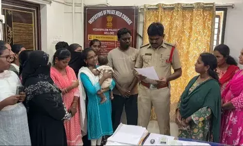 Volunteers submitting a complaint to the police personnel at fifth town police station in Nellore on Sunday