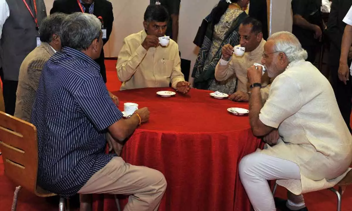 File photo of Prime Minister Narendra Modi savouring a cup of Araku coffee along with Chief Minister  N Chandrababu Naidu and then AP Governor ESL Narasimhan during his visit to Visakhapatnam