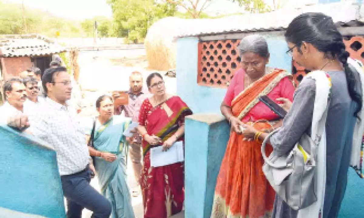 File photo of government staff disbursing pension to a woman beneficiary in Tirupati district
