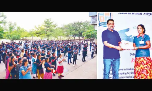 A woman worker receiving payment receipt from Rockworth System Furniture India Pvt Ltd president Shailesh Kumar Singh in Sri City on Wednesday