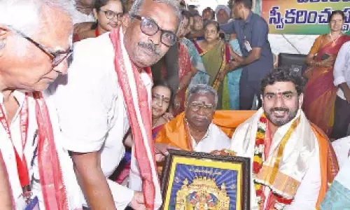 Mahan Kali temple authorities presenting a portrait of Goddess Mahan Kali to Minister Nara Lokesh at the temple on Thursday