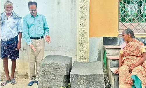Archaeologist and CEO, Pleach India Foundation Dr E Sivanagireddy with 12th century inscription