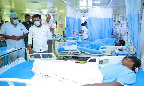 Minister for Labour Vasamsetti Subhash consoling injured workers of cement company in  a hospital in Vijayawada on Monday