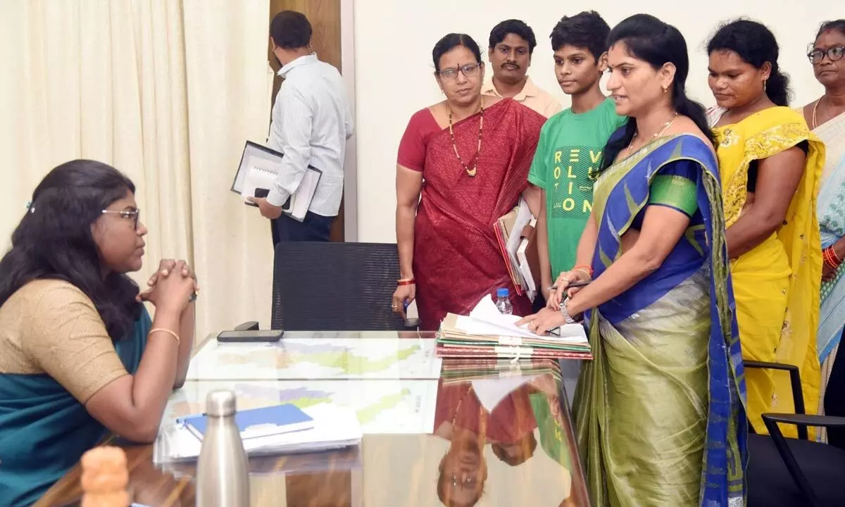 The boy  being handed over to mother in the presence of district  collector K Vetri Selvi in Eluru on Tuesday