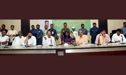 Minister Kolusu Parthasarathy and other officials speaking at the meeting in Eluru on Thursday