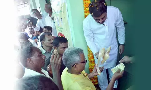 Civil supplies minister Nadendla Manohar distributes subsidised rice and red gram at Auto Nagar APIIC colony Rythu Bazar in Vijayawada on Thursday
