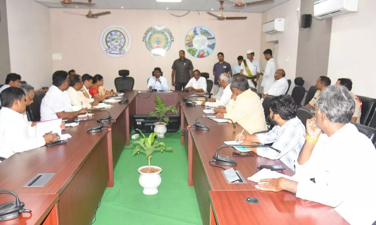 Collector P Arun Babu addressing a review meeting in Narasaraopet on Monday. MLA Dr Chadalavada Aravind Babu is also seen