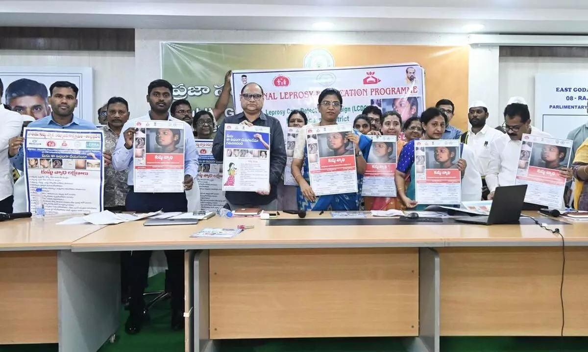 Collector P Prasanthi, DM&HO Dr K Venkateswara Rao and others unveiling poster of ‘National Leprosy Eradication Programme’ in Rajamahendravaram on Monday