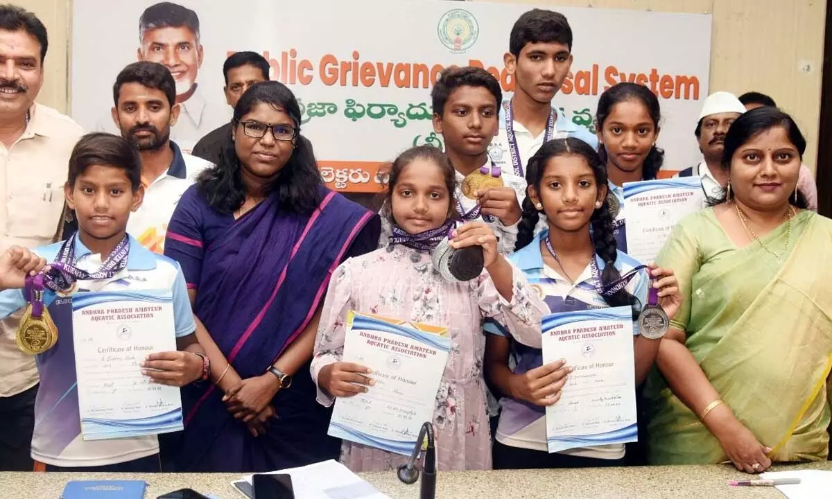 Collector K Vetri Selvi and joint collector Lavanyaveni congratulating the winners of swimming championship in Eluru on Monday