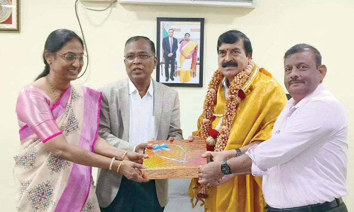 Central University of Andhra Pradesh Vice-Chancellor S A Kori felicitating Anantapur MP Ambica Lakshminarayana at the university office