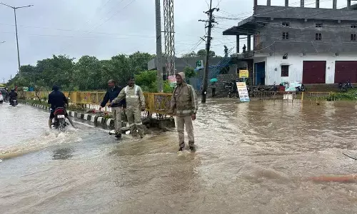 The Mulugu police station was cut off from the mainstream with the inundation of the approach road following heavy rains for the last three days submerging the Rallawagu bridge