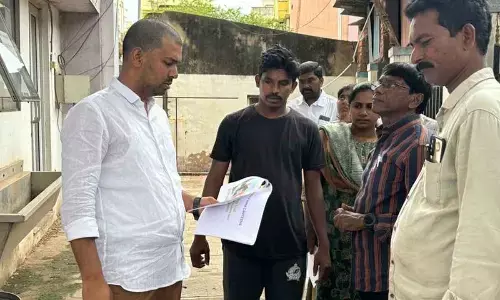 Municipal officials inspecting a location at 19th division at Muthukuru Gate center in Nellore on Sunday