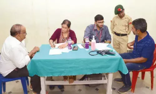 Doctors examining patients at the medical camp held at Varadaiahpalem Zilla Parishad High School on Sunday