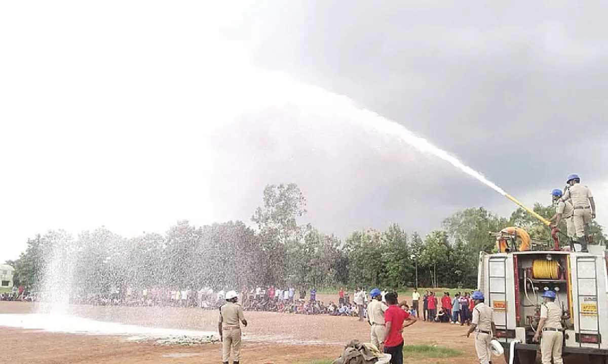 Fire personnel imparting practical training in fire-fighting to NCC cadets