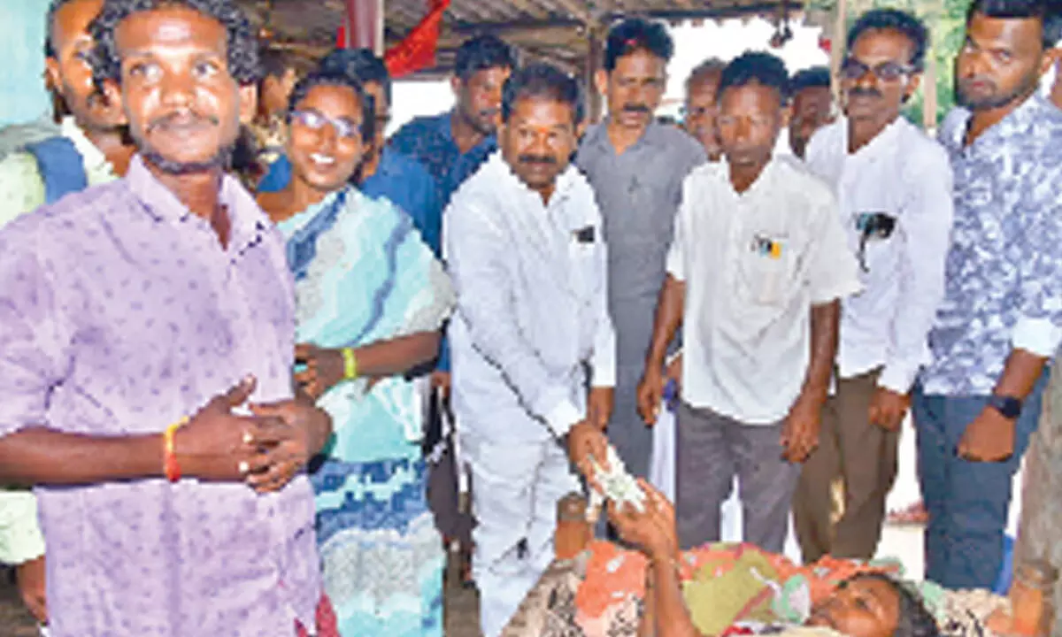 Minister Dr Dola Sree Bala Veeranjaneya Swamy distributing pension to a beneficiary in Pakala village in Prakasam district on Thursday