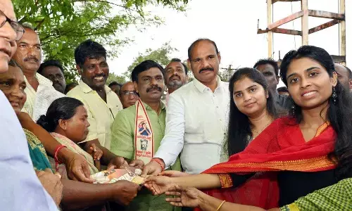 Minister Kolusu Parthasarathy distributing NTR Bharosa pensions along with Joint Collector Dhatri Reddy at Katrenipadu village in Eluru district on Thursday