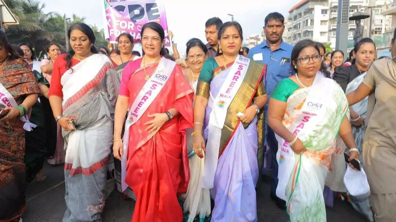 Home Minister Vangalapudi Anitha taking part in saree walk organised at R K Beach in Visakhapatnam on Sunday