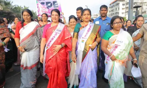 Home Minister Vangalapudi Anitha taking part in saree walk organised at R K Beach in Visakhapatnam on Sunday