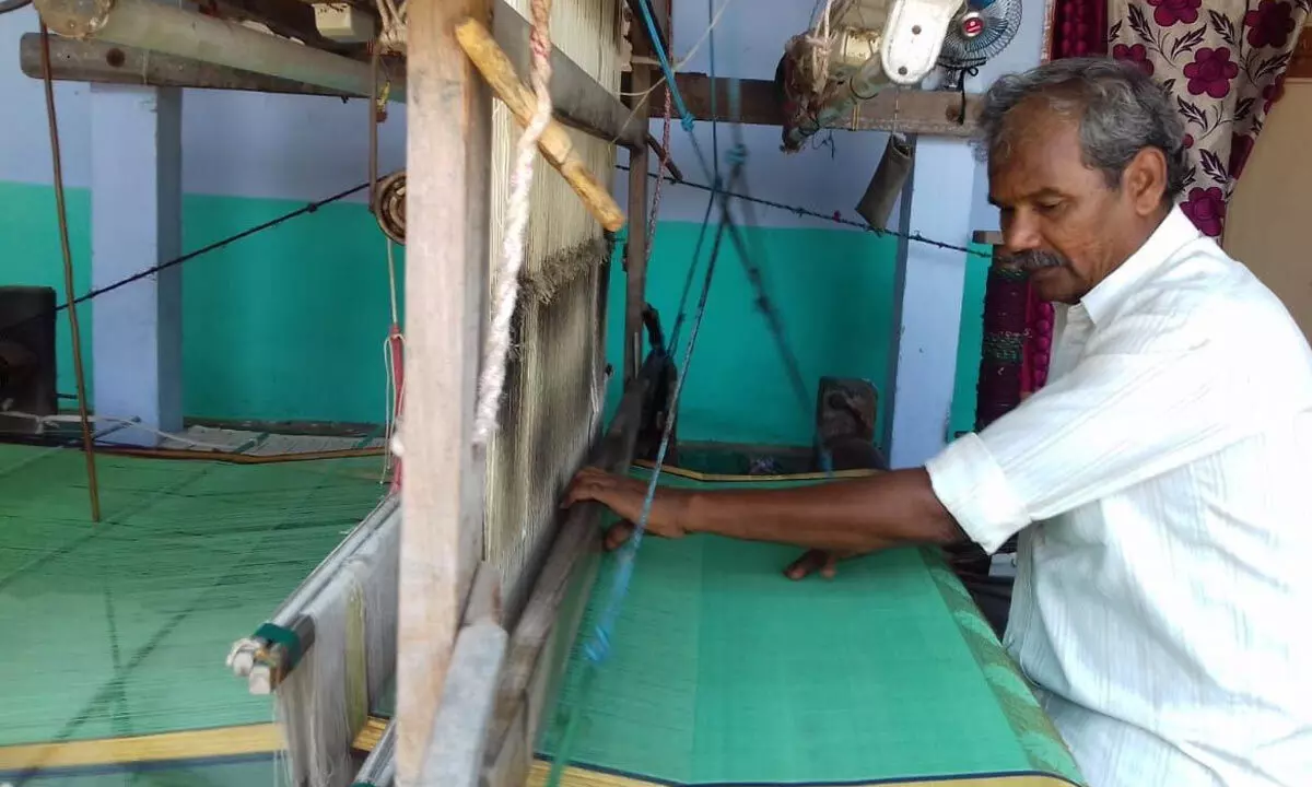 A weaver on the handloom at Eepurupalem in Chirala mandal in Bapatla district  							(File photo)