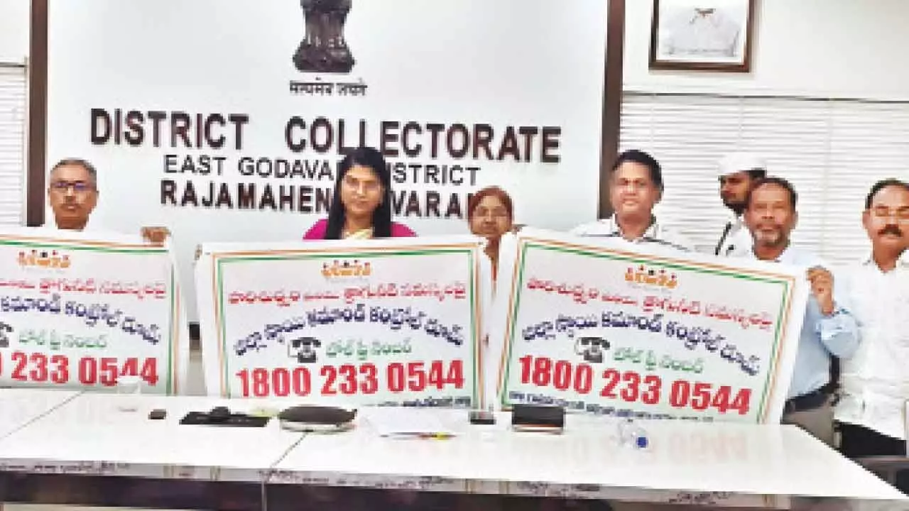 Collector P Prasanthi releasing posters on toll-free number of the district-level command control station