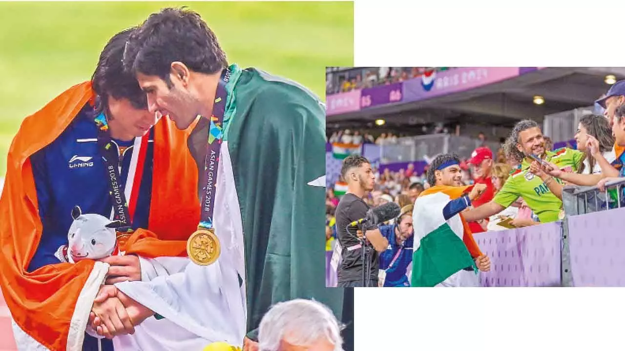 Gold medalist Indias Neeraj Chopra with bronze medalist Pakistans Arshad Nadeem at the medal ceremony of the mens javelin throw event during the 18th Asian Games 2018, in Jakarta, Indonesia.; Silver medalist Indias Neeraj Chopra being congratulated by a Pakistani fan in Paris, France on Thursday.