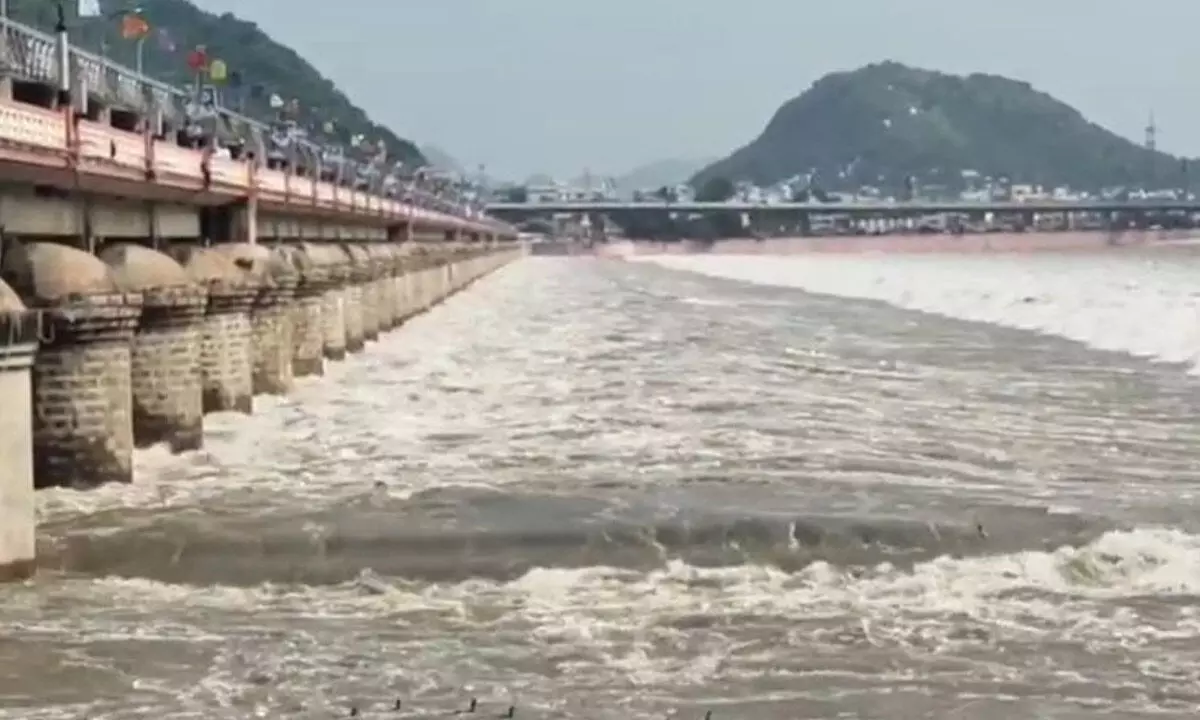 Floodwater gushing out from Prakasam Barrage at Vijayawada on Sunday