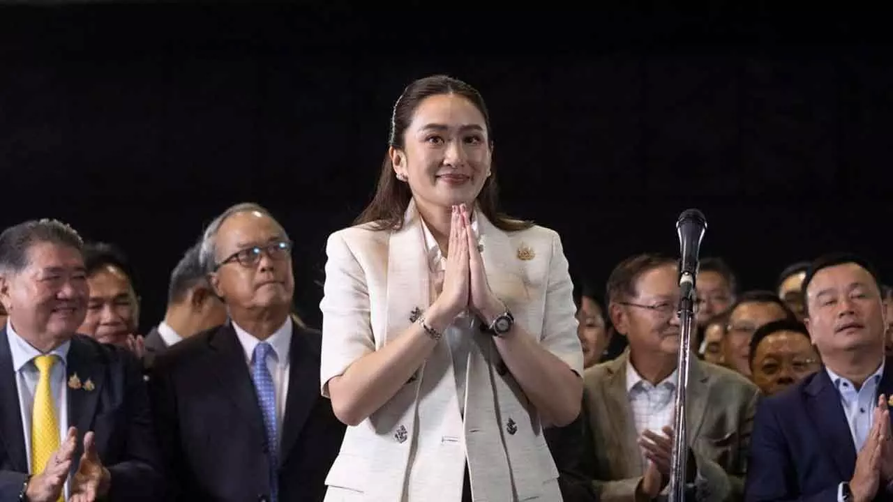 Thailands Prime Minister-designate Paetongtarn Shinawatra greets reporters during a press conference at Pheu Thai party headquarters in Bangkok, Thailand on Friday