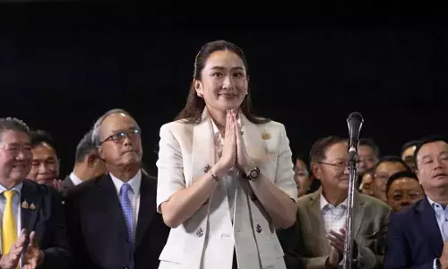 Thailands Prime Minister-designate Paetongtarn Shinawatra greets reporters during a press conference at Pheu Thai party headquarters in Bangkok, Thailand on Friday