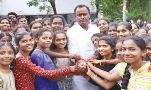 KGBV students of Choutuppal tying Rakhis to MLA Rajgopal Reddy