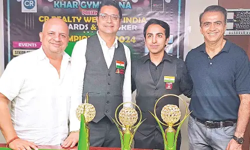 Advani clinches grand double