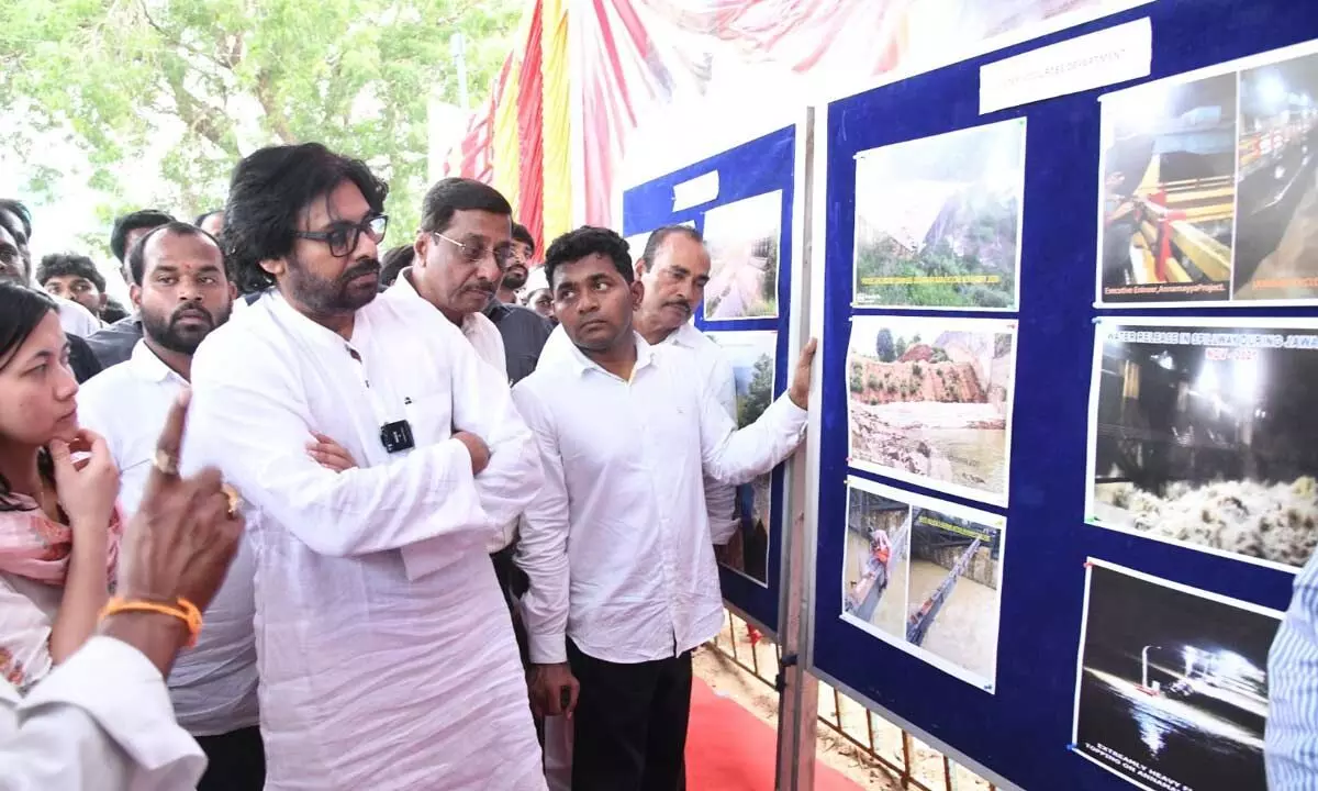 Deputy Chief Minister Pawan Kalyan going through a photo exhibition  at a Gram Sabha at Mysuruvaripalle in Annamayya district on Friday