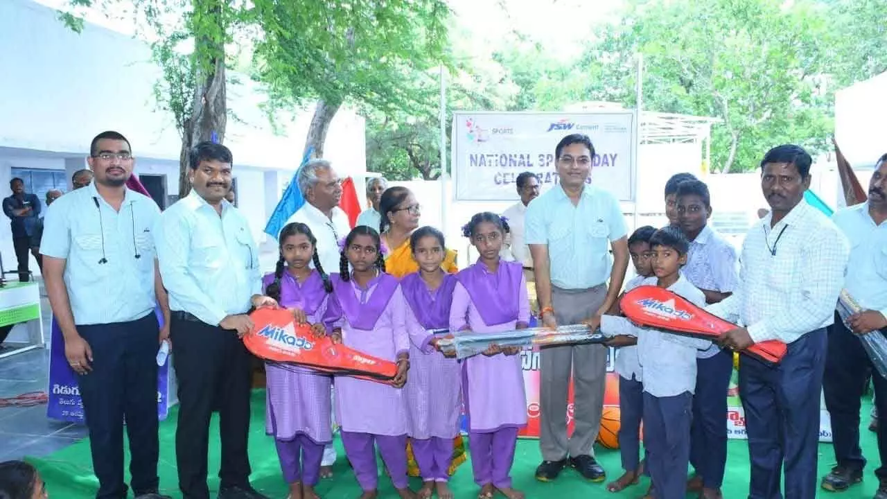 JSW Cement Limited Unit Head Navneet Chauhan and others handing over sports kits to students at Bilakalaguduru village on Thursday