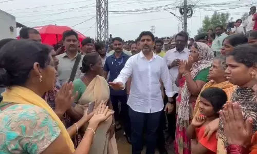 Minister for Rural Development and Communications Nara Lokesh interacting with victims in Mangalagiri on Sunday