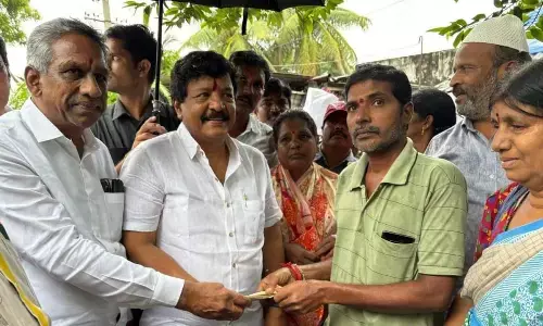 Minister Kandukuri Durgesh and former MLA Burugupalli  Sesharao distributing pension in Nidadavole on Saturday