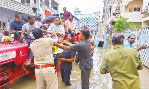 Home minister Vangalapudi Anitha distributing food on a tractor at Bhavanipuram in Vijayawada
