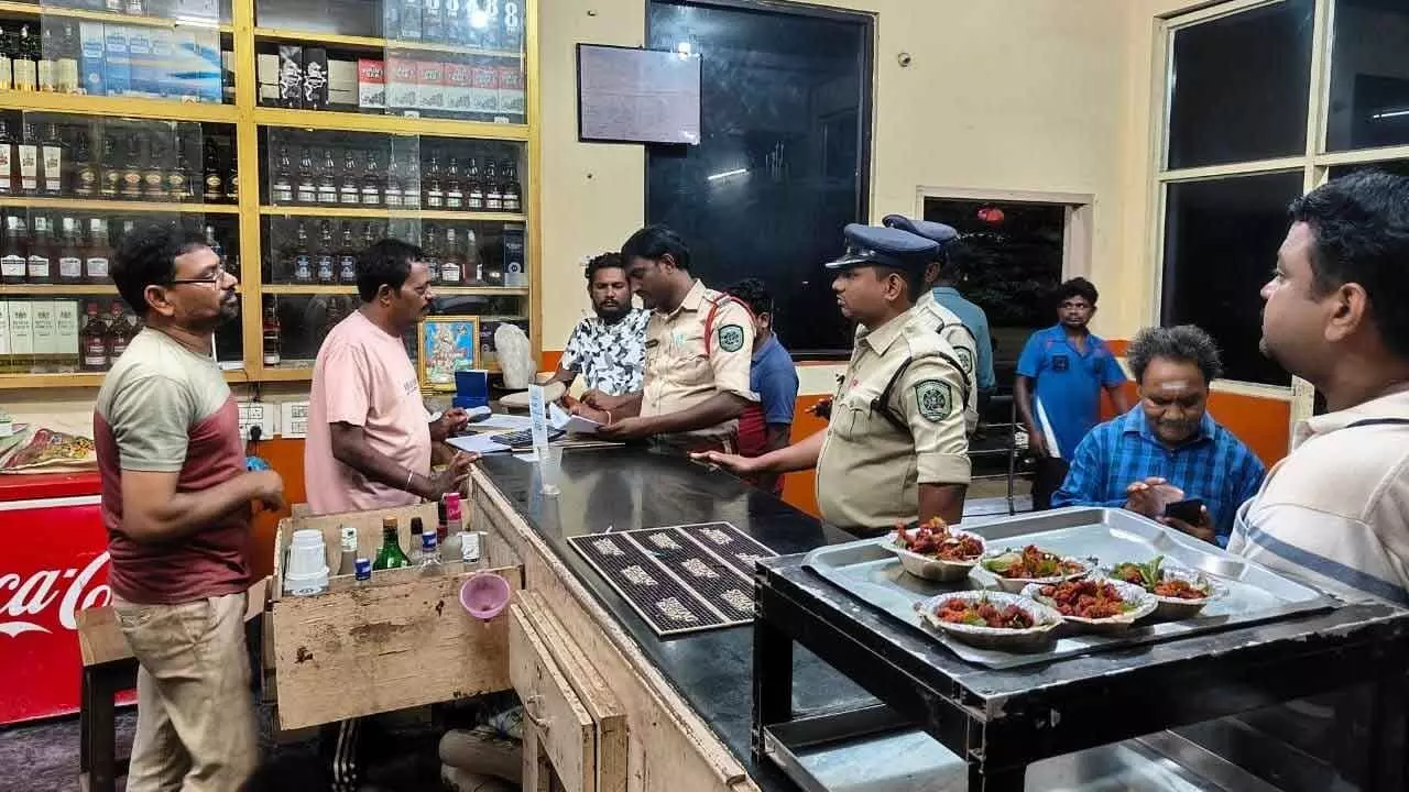 Police department officials verifying records in a restaurant and bar in Visakhapatnam