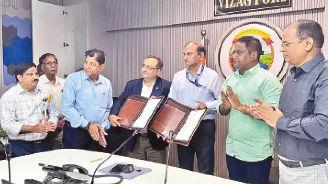 VPA and MECON officials exchanging MoU in Visakhapatnam  on Thursday