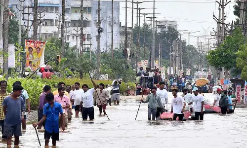People coming out from flood-affected areas of Singh Nagar in Vijayawada on Thursday    (Photo: Ch Venkata Mastan)