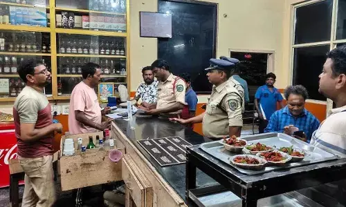 Police department officials verifying records in a restaurant and bar in Visakhapatnam