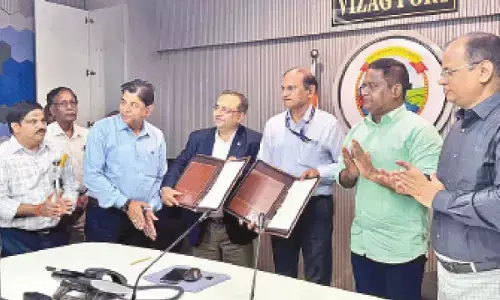 VPA and MECON officials exchanging MoU in Visakhapatnam  on Thursday