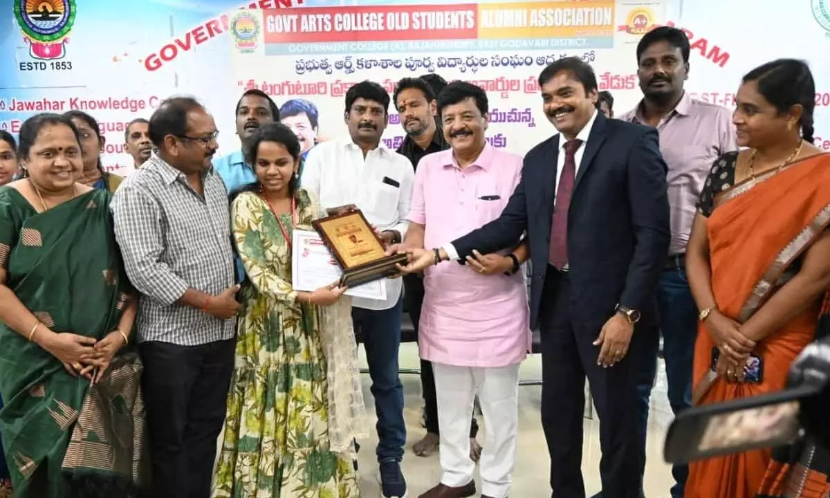 Minister Kandula Durgesh, Government Degree College Principal RK Ramachandra and Alumni Association president Mulla Madhav presenting awards to meritorious students in Rajamahendravaram on Friday