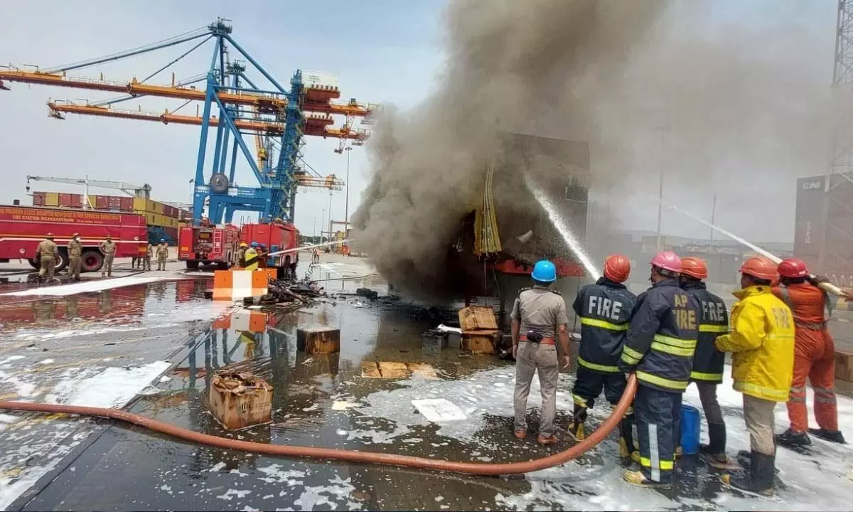 Firefighters dousing the fire of the container at VCTPL on Saturday