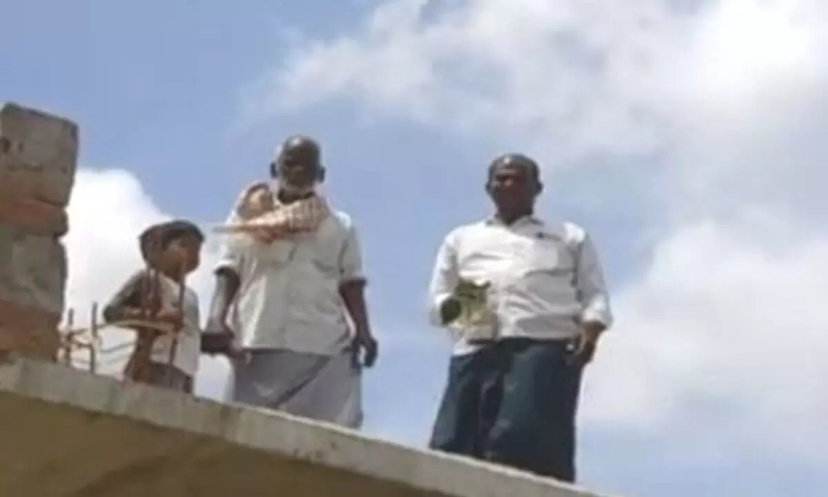 Urukundu along with his father and son threatening to commit suicide from his house rooftop  in Nandyal on Saturday