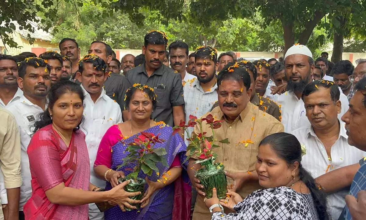 Staff welcoming BC Welfare Minister S Savitha and ex-Minister Palle Raghunatha Reddy at Jyothirao Phule Residential School in  Bukkapatnam on Sunday