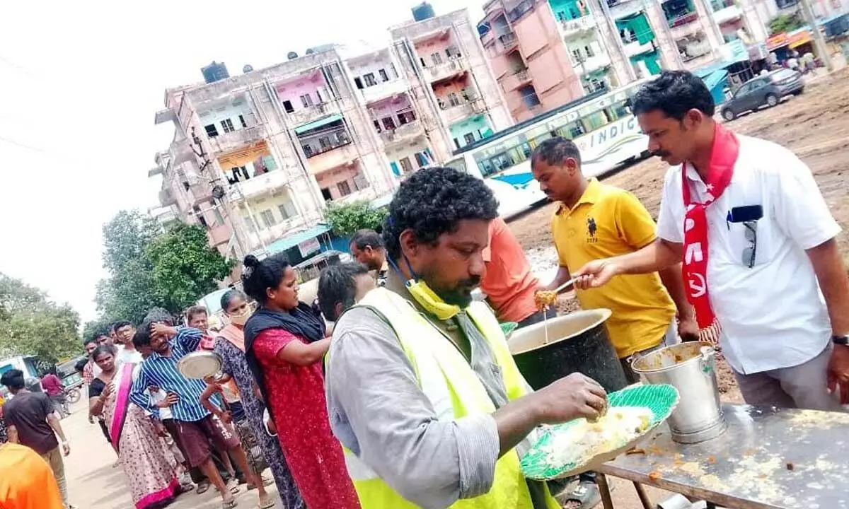 CPM arranging food for flood victims in a colony in Vijayawada on Sunday