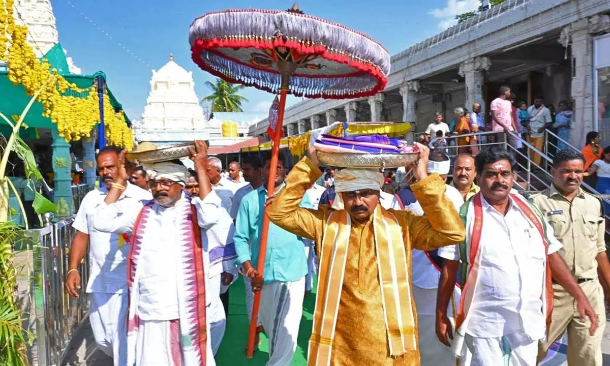 TTD EO J Syamala Rao carrying clothes to present them to Sri Varasiddhi Vinayaka Swamy at Kanipakam on Sunday