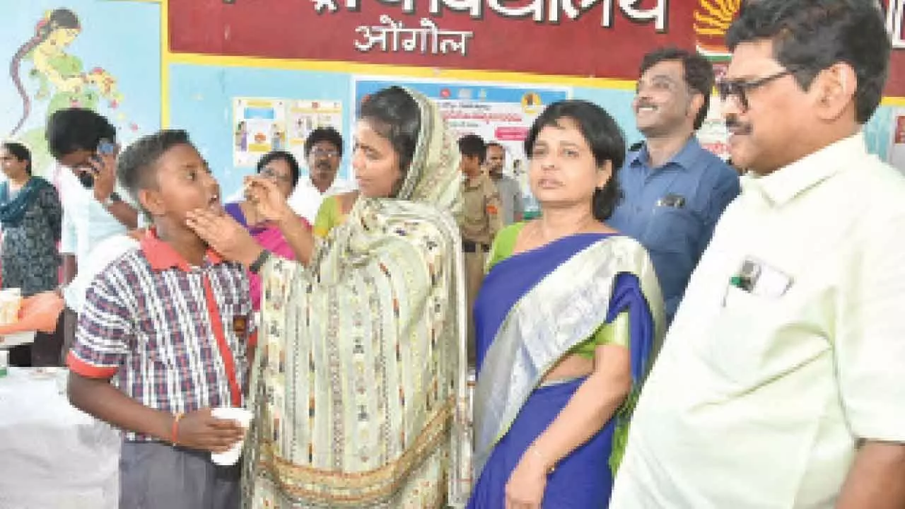 Collector A Thameem Ansariya administering Albendazole tablets to a student at Kendriya Vidyalaya in Ongole on Tuesday