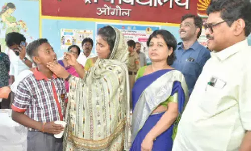 Collector A Thameem Ansariya administering Albendazole tablets to a student at Kendriya Vidyalaya in Ongole on Tuesday