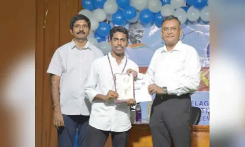 Dayala Avinash from the Civil Engineering Department receiving the Best NSS Volunteer Award from Vice-Chancellor Prof  P Venkateswara Rao at VR Siddhartha Engineering College in Vijayawada on Tuesday