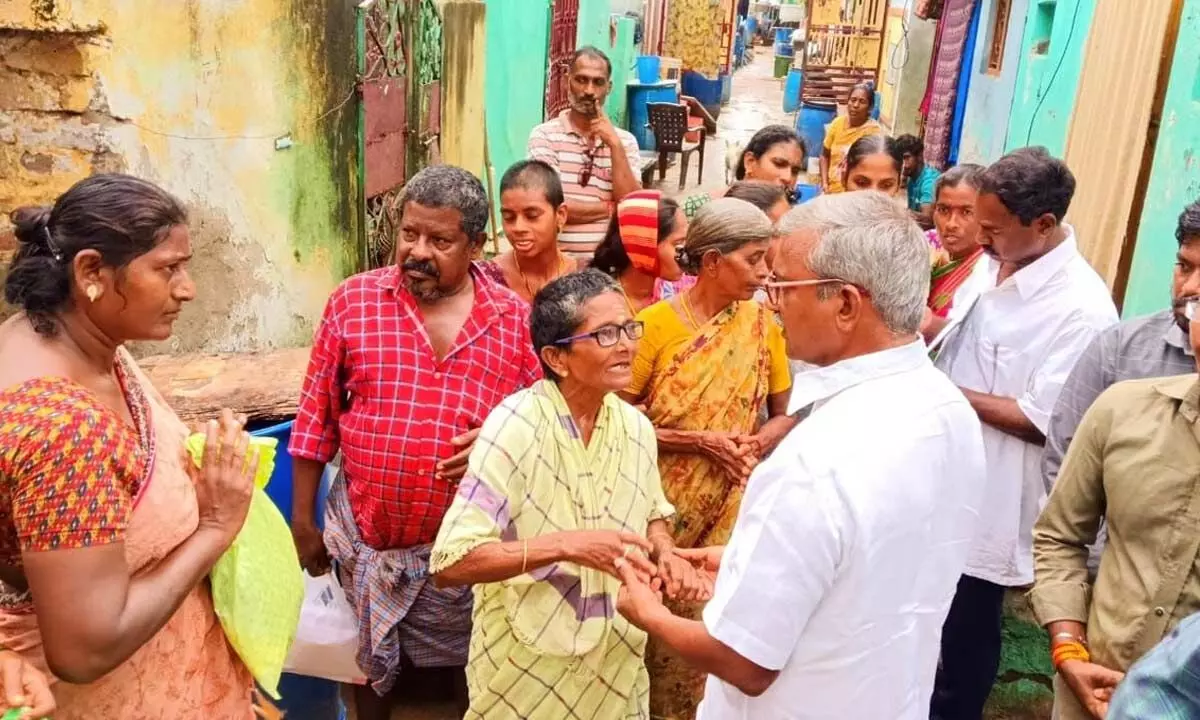 CPM leader Ch Babu Rao and others visiting the flood victims in Vijayawada on Friday